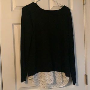 Black sweater type shirt with a polka dot design